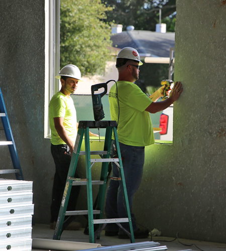 subcontractors adding windows for lighting